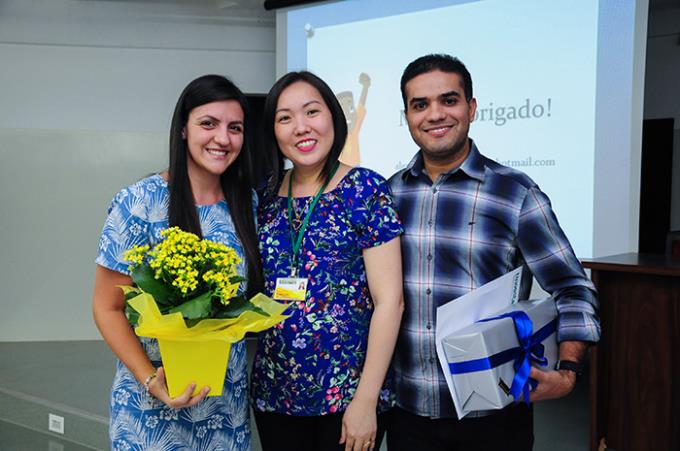 Egresso Alexandre Santana com sua esposa e a coordenadora do curso, Clara Takigawa durante evento acadêmico